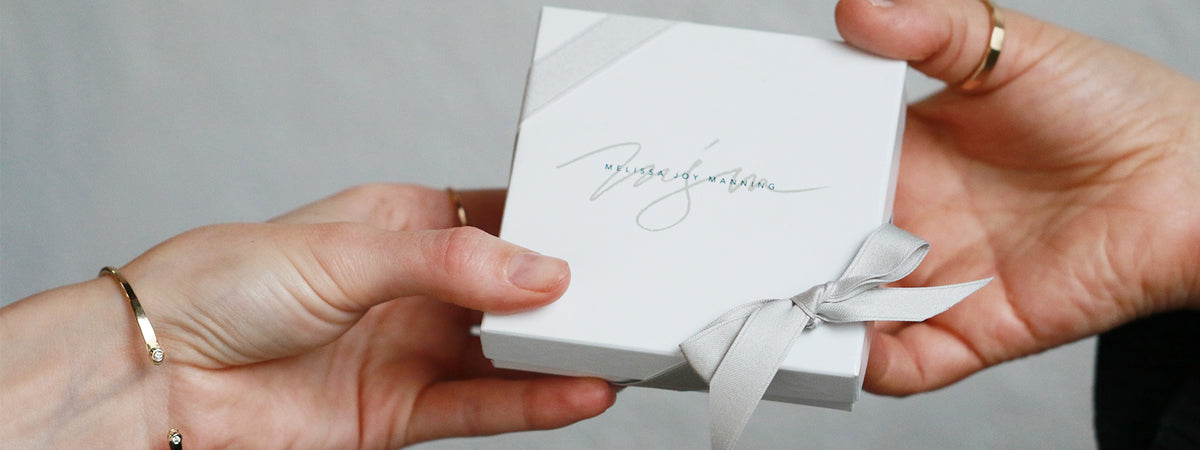 hands giving a gift box