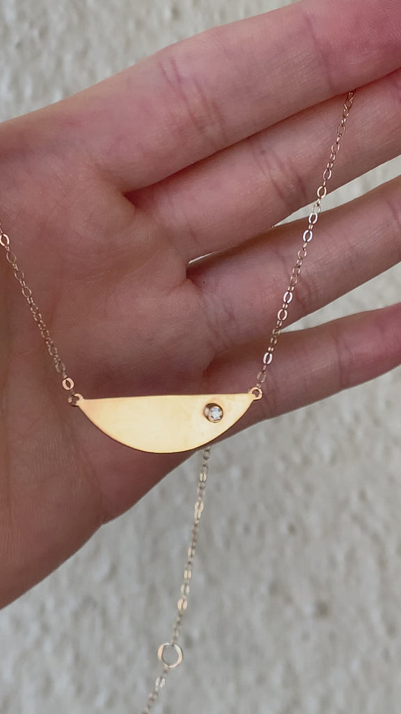 demonstrating the semi circle diamond necklace in motion